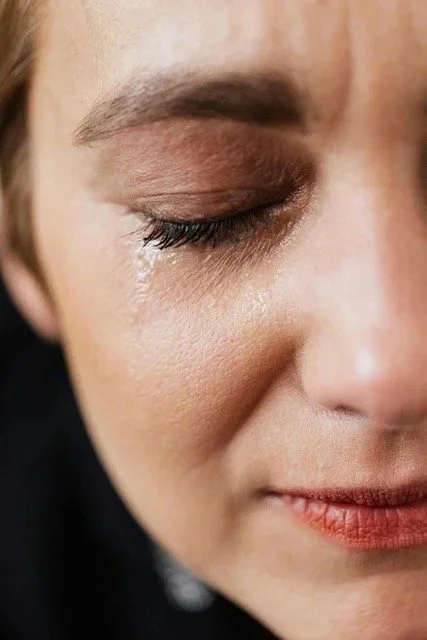 Woman crying after discovering her spouse's affair, seeking infidelity therapy for support.