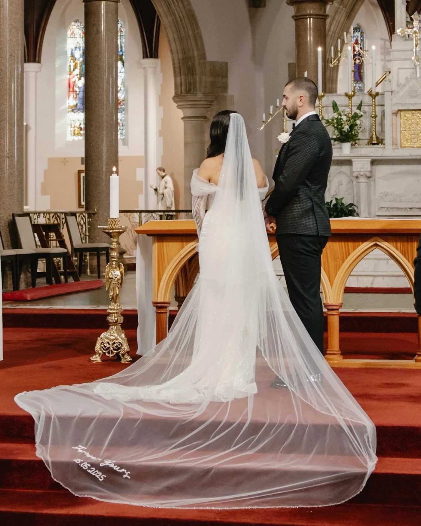 This stunning cathedral veil was crafted from four meters of English tulle, adorned with 12.5 meters of delicate glass crystal beading along the edges and 15 meters of intricate hand stitched sunray sequins. 
At the base, a heartfelt message shines b