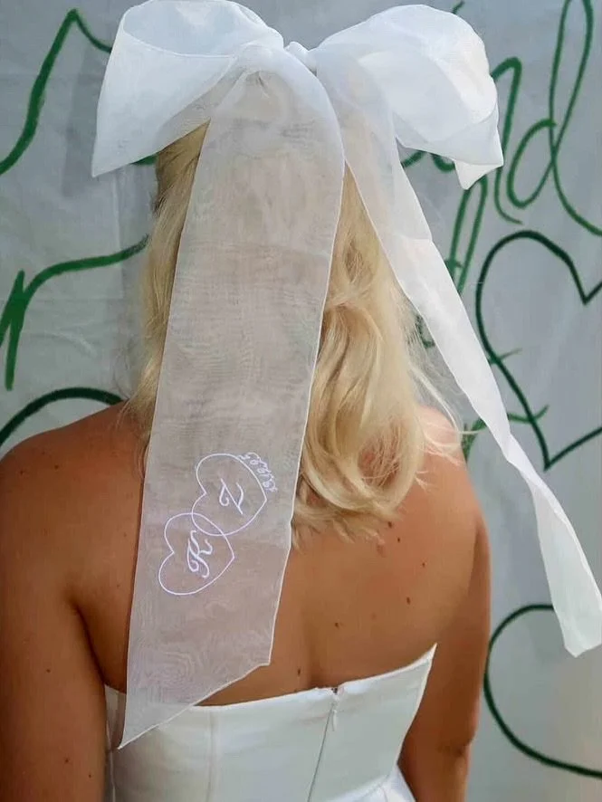 Bow moment for the bride to be 
Custom organza hair bow embroidered with K + Z and their wedding date. Espresso martini optional ☕️✨