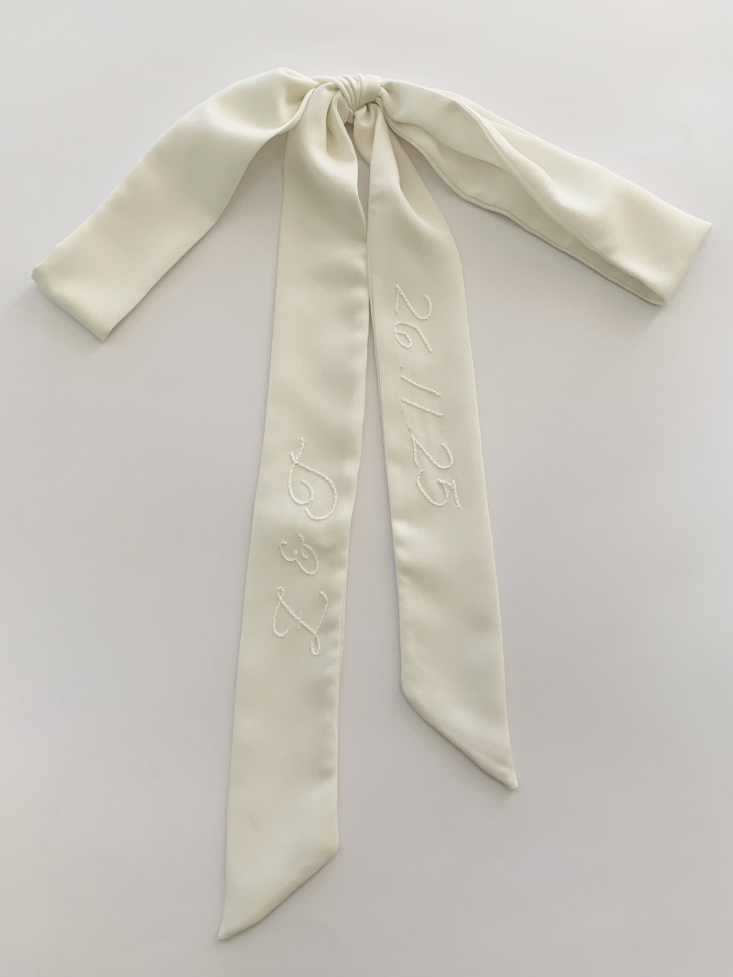 If you&rsquo;re choosing just one personalised detail, make it something you can wear more than once.

Made from soft ivory french crepe, this piece is designed to be worn, styled, and held onto. You can style it:

Around your bouquet.
Tied at the ba