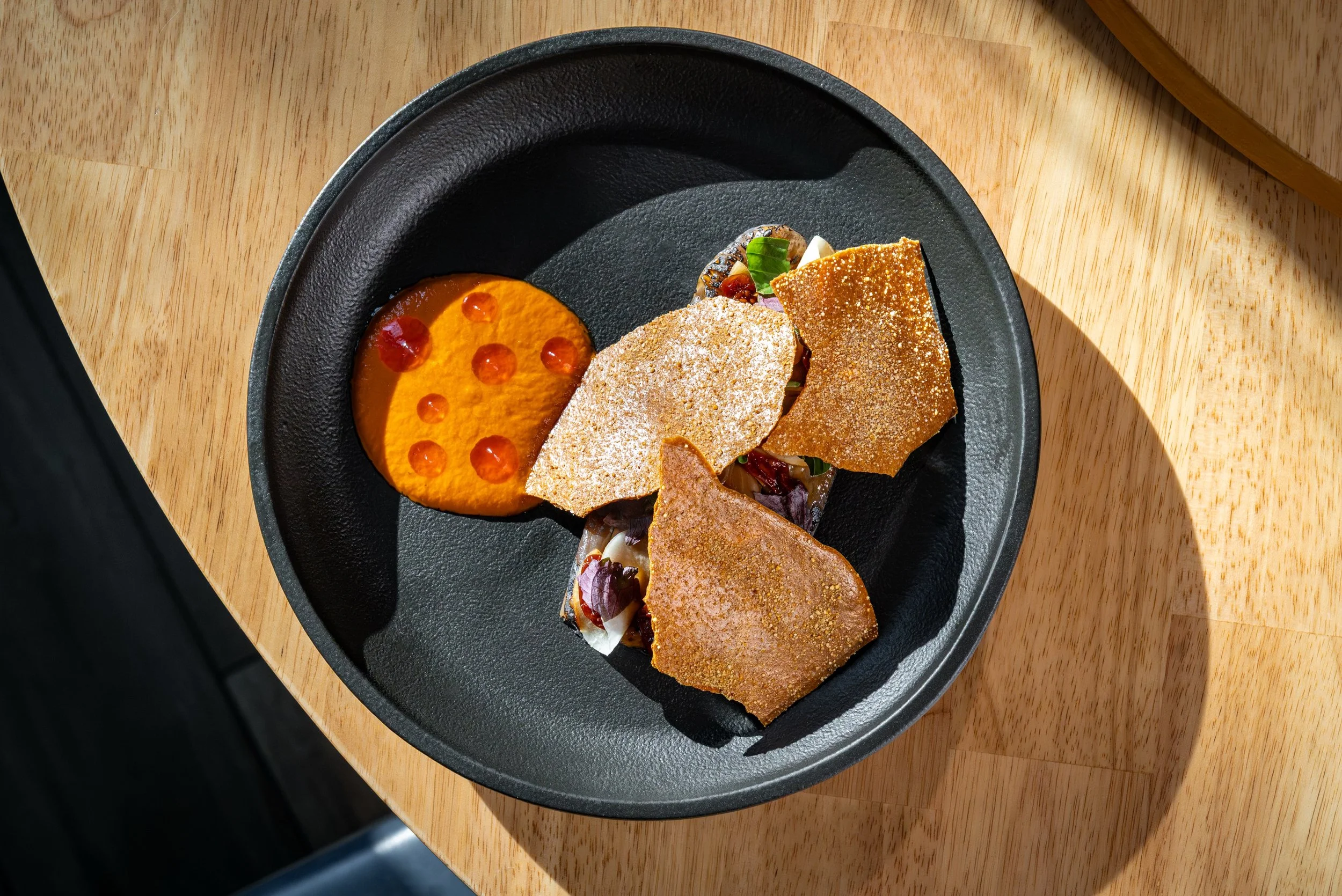 Our Charred Eggplant begins with canh c&agrave; bung, a comforting soup from Northern Vietnam&rsquo;s Red River Delta where tender eggplant, tomato, and fragrant t&iacute;a t&ocirc; come together in a light broth.

For our version, we took those fami