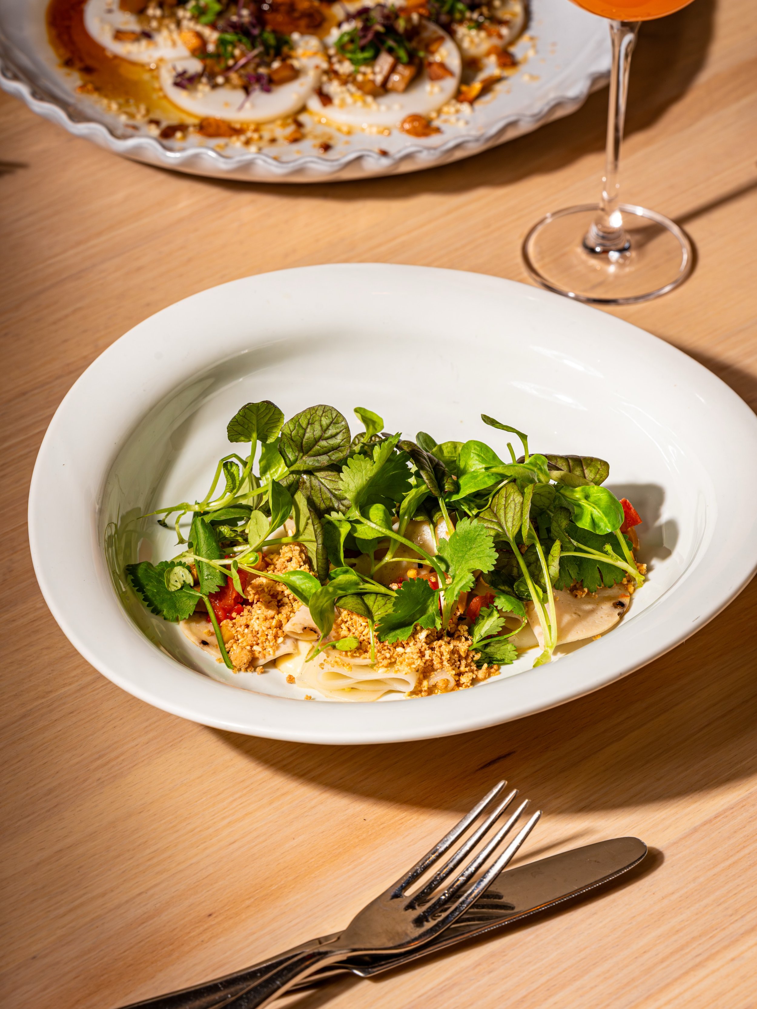 Our &ldquo;Muffuletta&rdquo; | B&aacute;nh Ướt brings together a New Orleans Italian sandwich and a Vietnamese rice noodle dish, with chả lụa connecting the two.

Chả lụa is a smooth, savory Vietnamese pork sausage, often described as Vietnamese mort