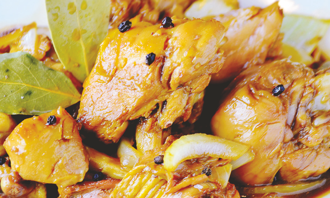 Chicken simmered in garlic soy sauce and vinegar with bay leaves, peppercorns, served over potatoes.