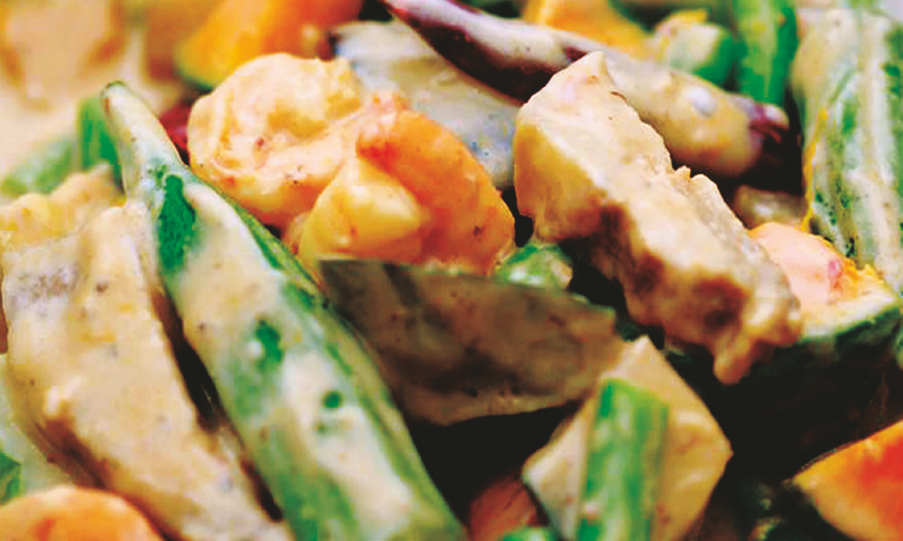 Pinakbet vegetables including okra and eggplant simmered in coconut sauce with pork and shrimp.