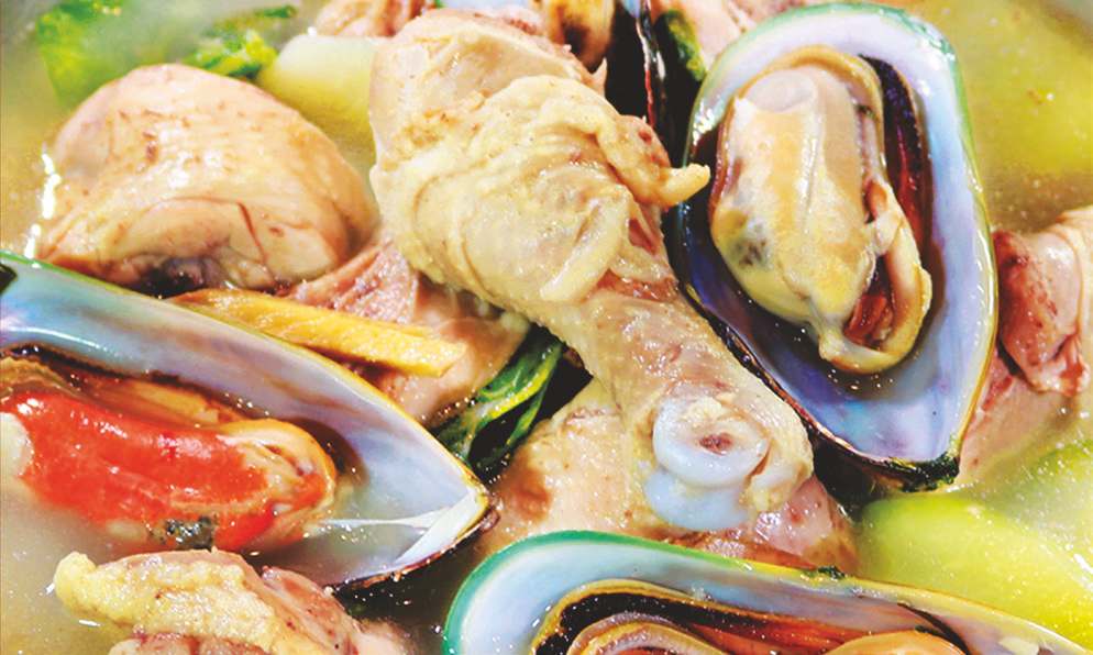 Chicken and green mussels in garlic, ginger, lemongrass broth with chayote, pepper leaves, and spinach.