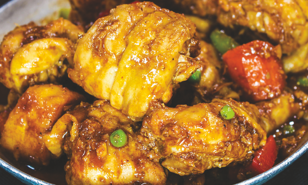 Spicy chicken stew with carrots, green peas, potatoes and bell pepper