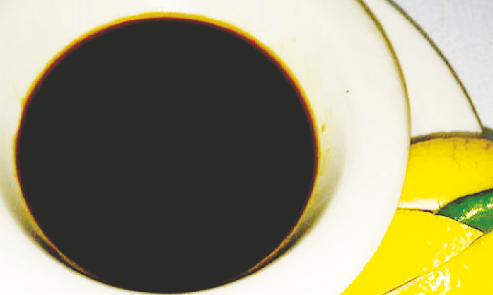 Dark pork barbecue sauce in a small bowl