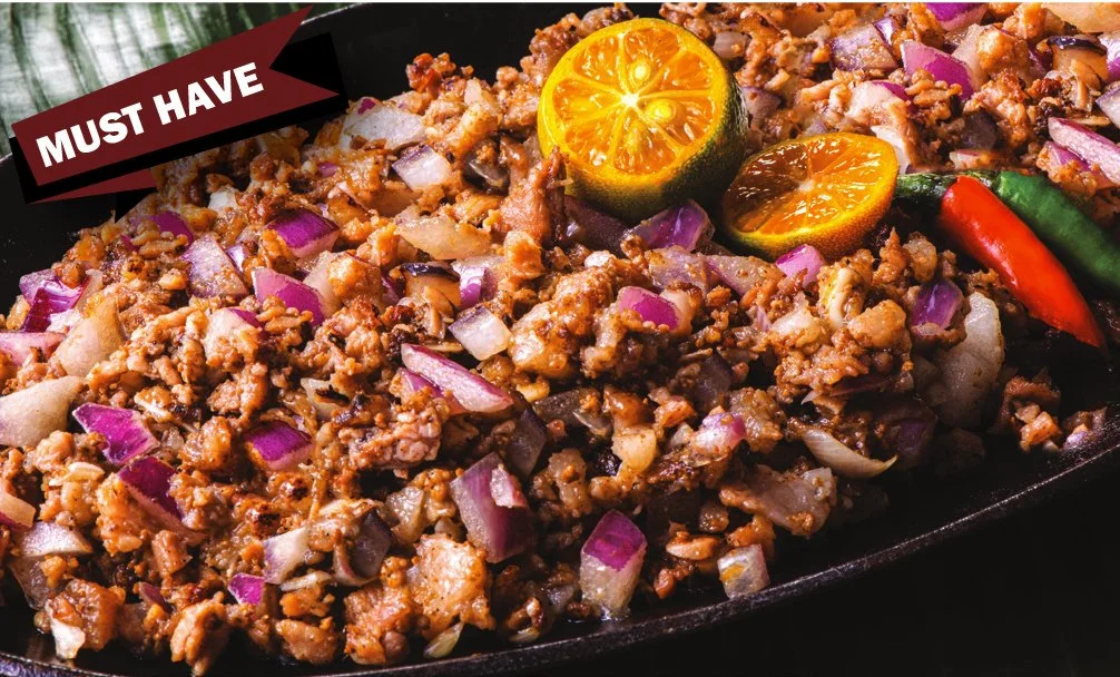 Spicy minced pork on sizzling plate topped with onions and chili