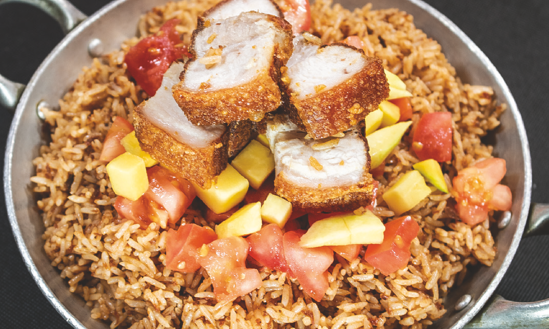 Rice with shrimp paste, crispy pork belly, diced mango, and tomatoes
