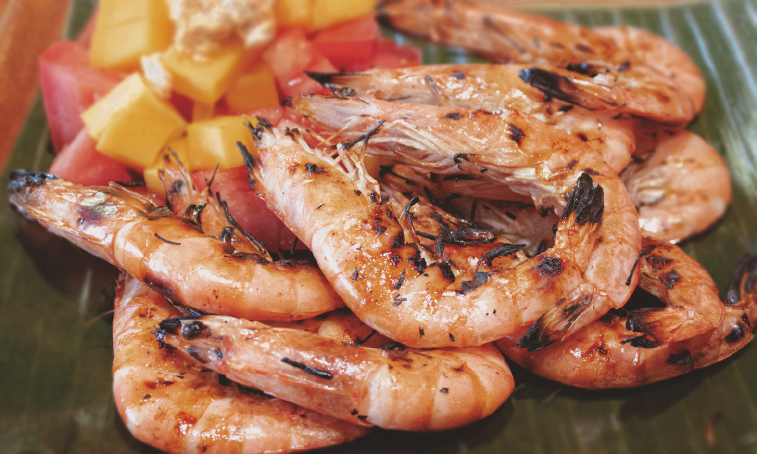 Seasoned grilled prawns with diced tomatoes.