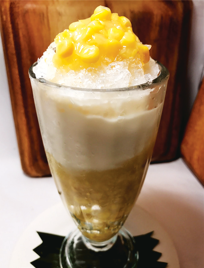 Corn kernels with milk, sugar, and shaved ice in a glass