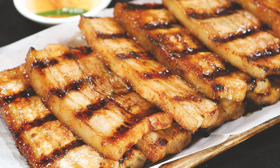 Grilled marinated pork belly with slight char marks