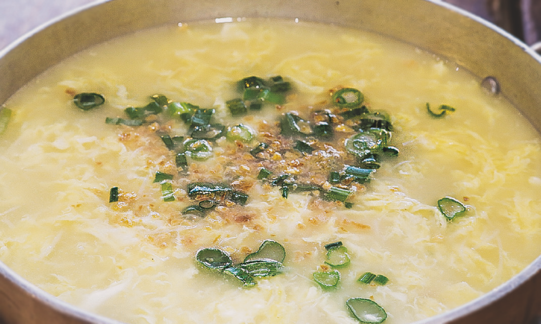Egg noodles in broth topped with fried garlic and green onions