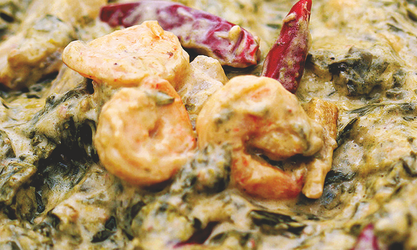 Chopped taro leaves in coconut milk with shrimp and red chili peppers.