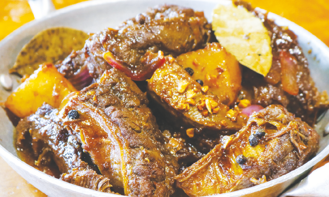 Brisket simmered in soy sauce, vinegar, bay leaf, peppercorns, and potatoes.