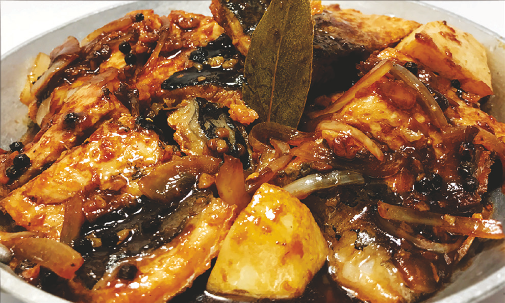 Boneless milkfish simmered in adobo sauce (vinegar, soy, peppercorns, bay leaf).
