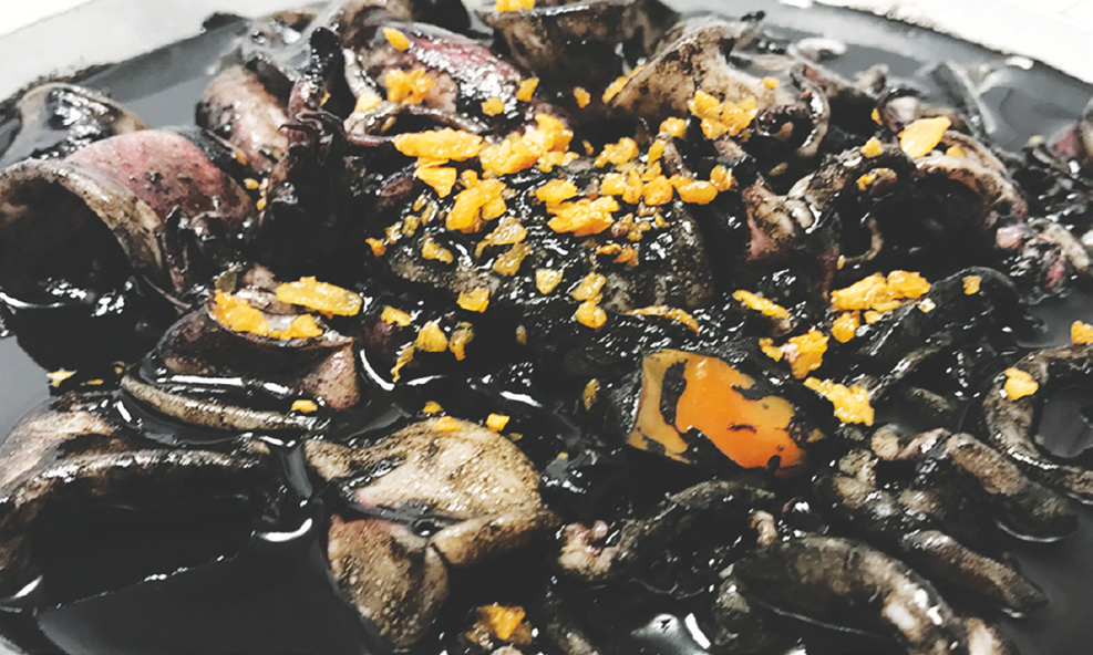 Squid cooked in its own ink with adobo sauce.