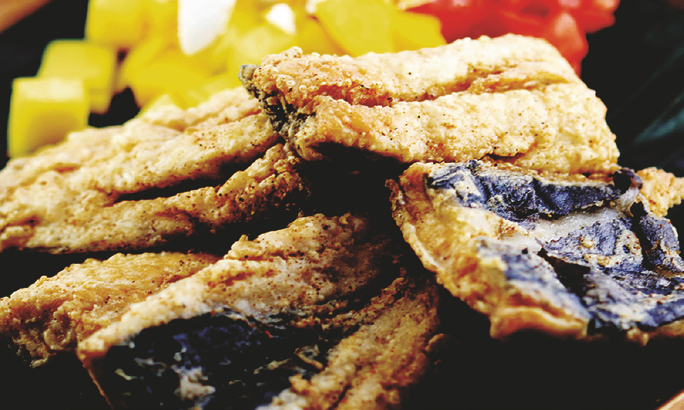Deep‑fried boneless milkfish with Ensaladang Kapampangan (sliced mango and tomato with salted egg).