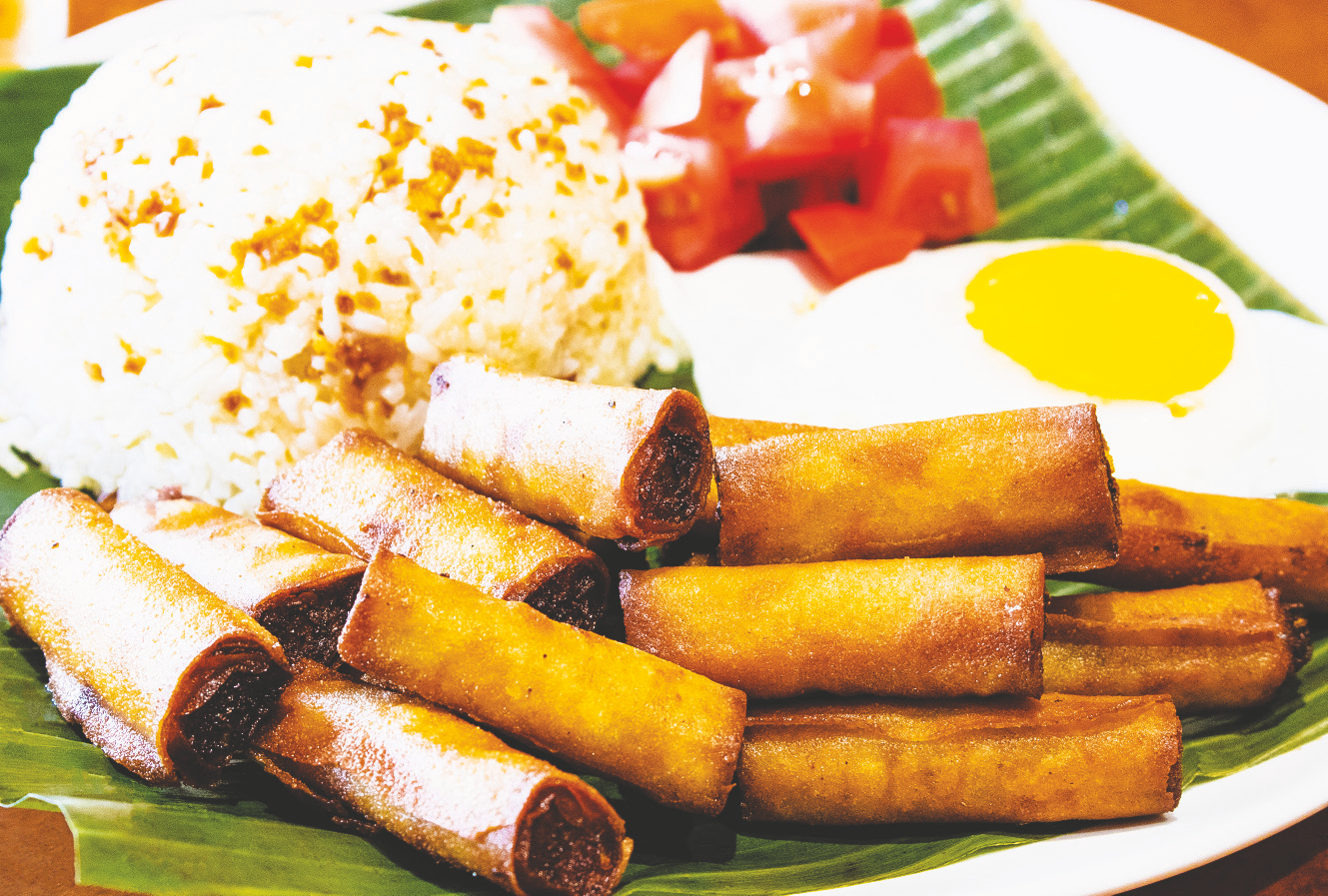 Fried spring rolls with ground chicken and vegetables served with rice, fried egg, and tomato