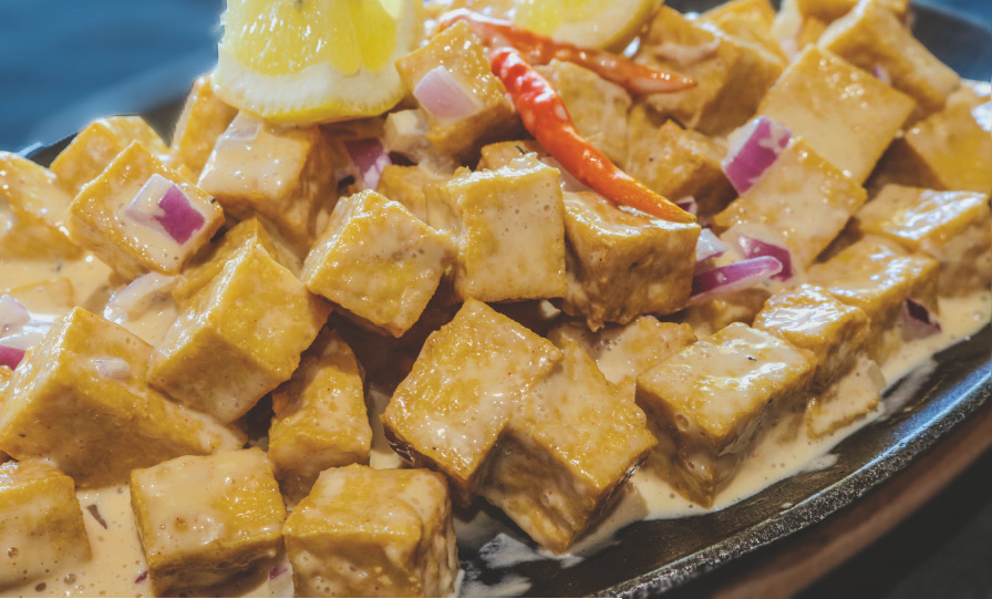 Chopped fried tofu with onions and peppers sautéed in savory sauce.