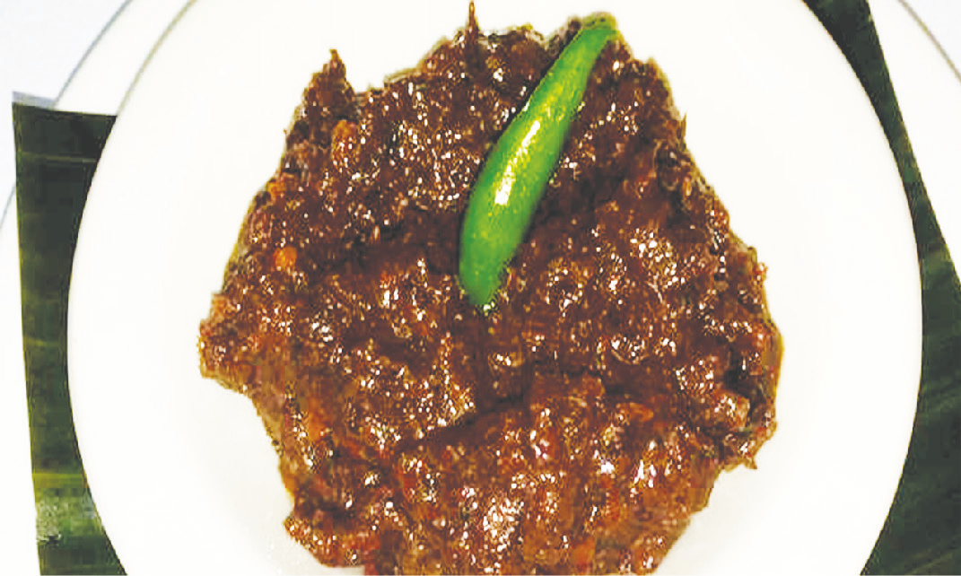 Dark sautéed shrimp paste served on a plate