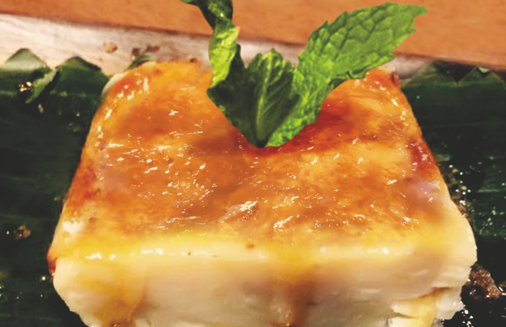 Coconut milk and corn pudding garnished with mint