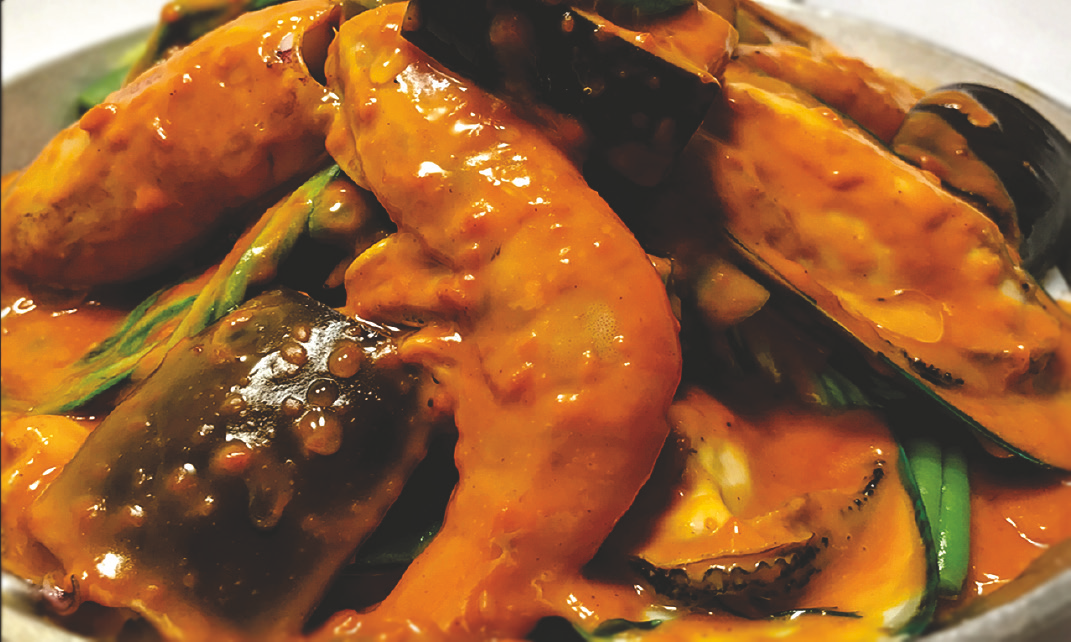 Squid, prawns, and mussels in peanut sauce with vegetables.