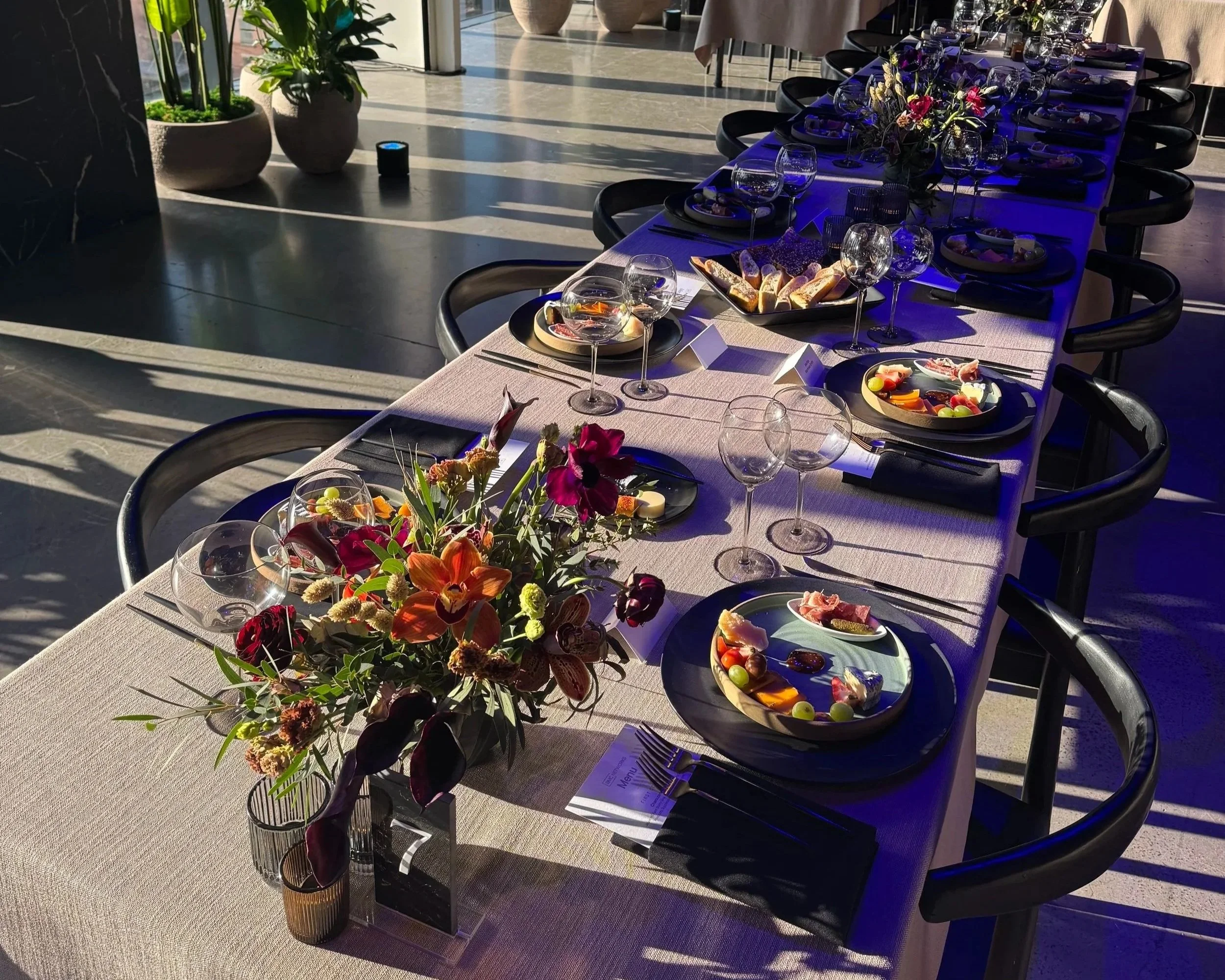 Tailored floral arrangements set against curated food and beverage.