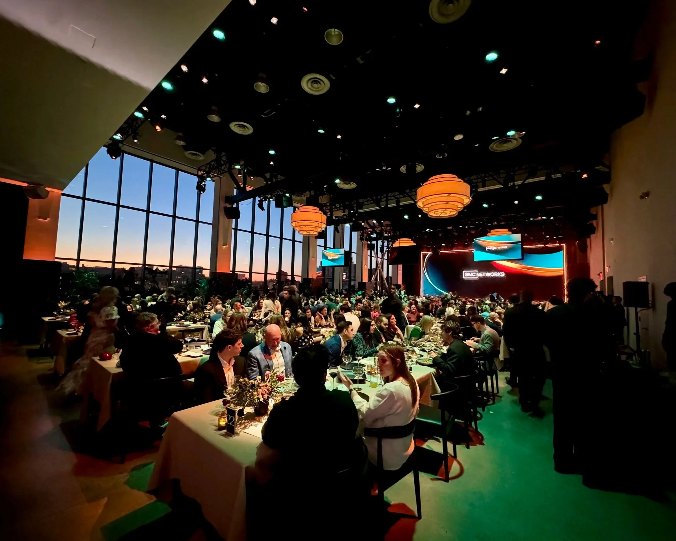 Wide shot view of presentation room filled with guests waiting for the keynote to commence.