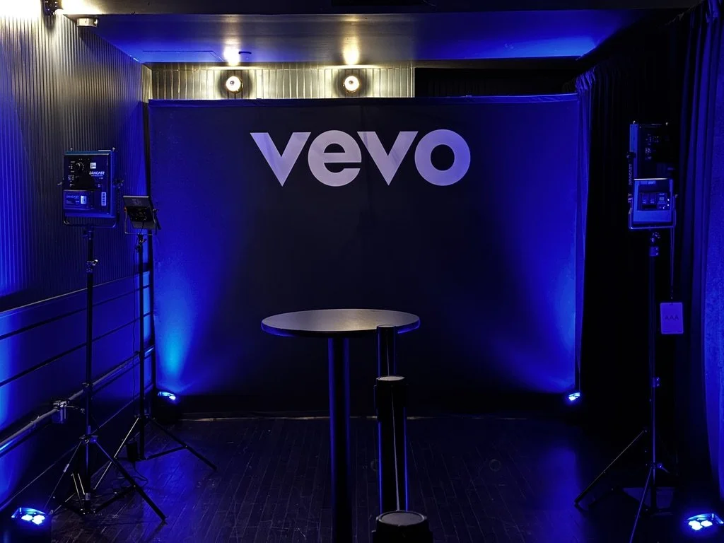 Step and Repeat backdrop with photography lighting for talent meet and greet moment.