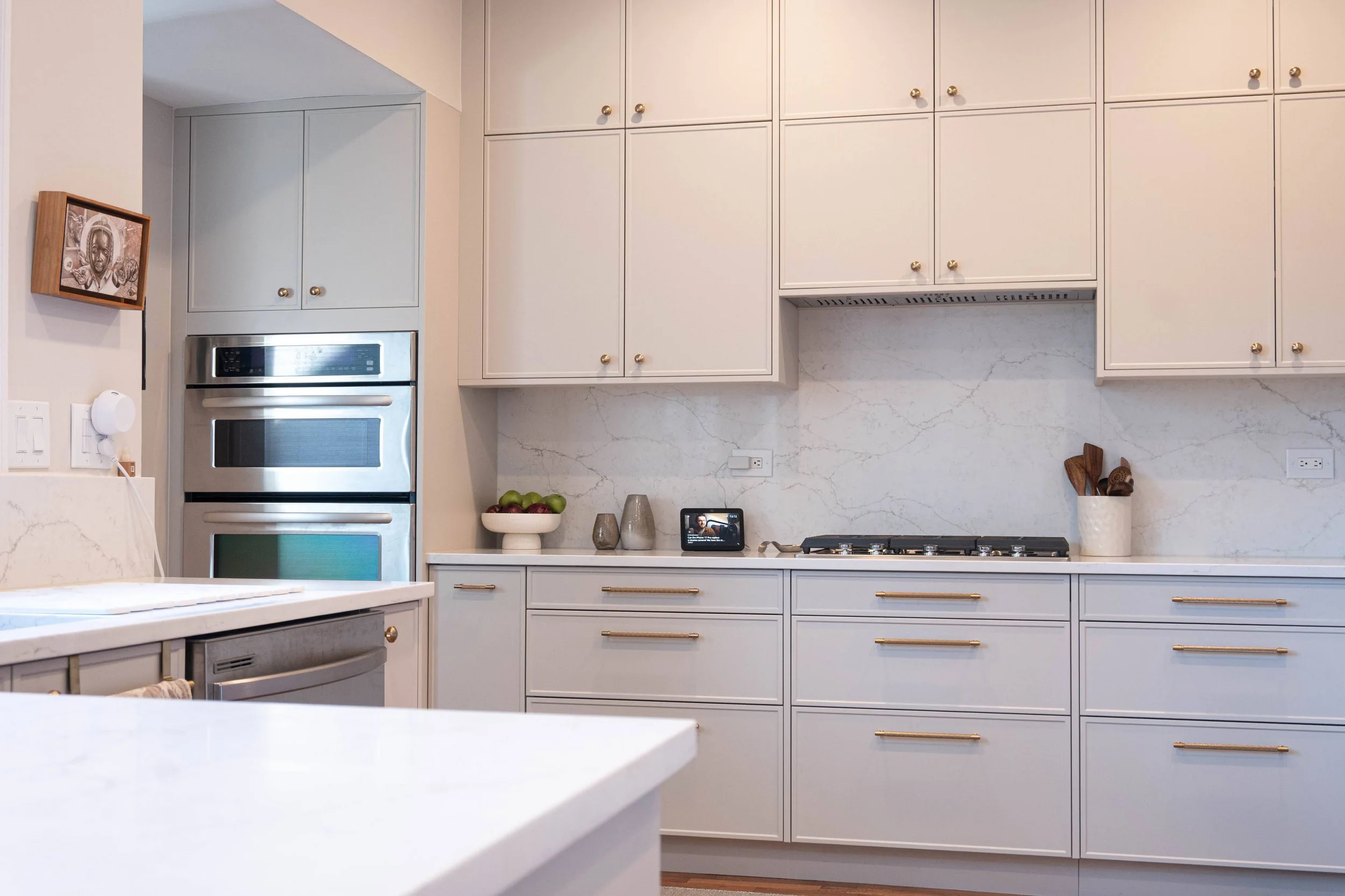 Perspective from the breakfast bar seating reveals a functional layout with stainless steel appliances and an optimized workflow for home chefs.