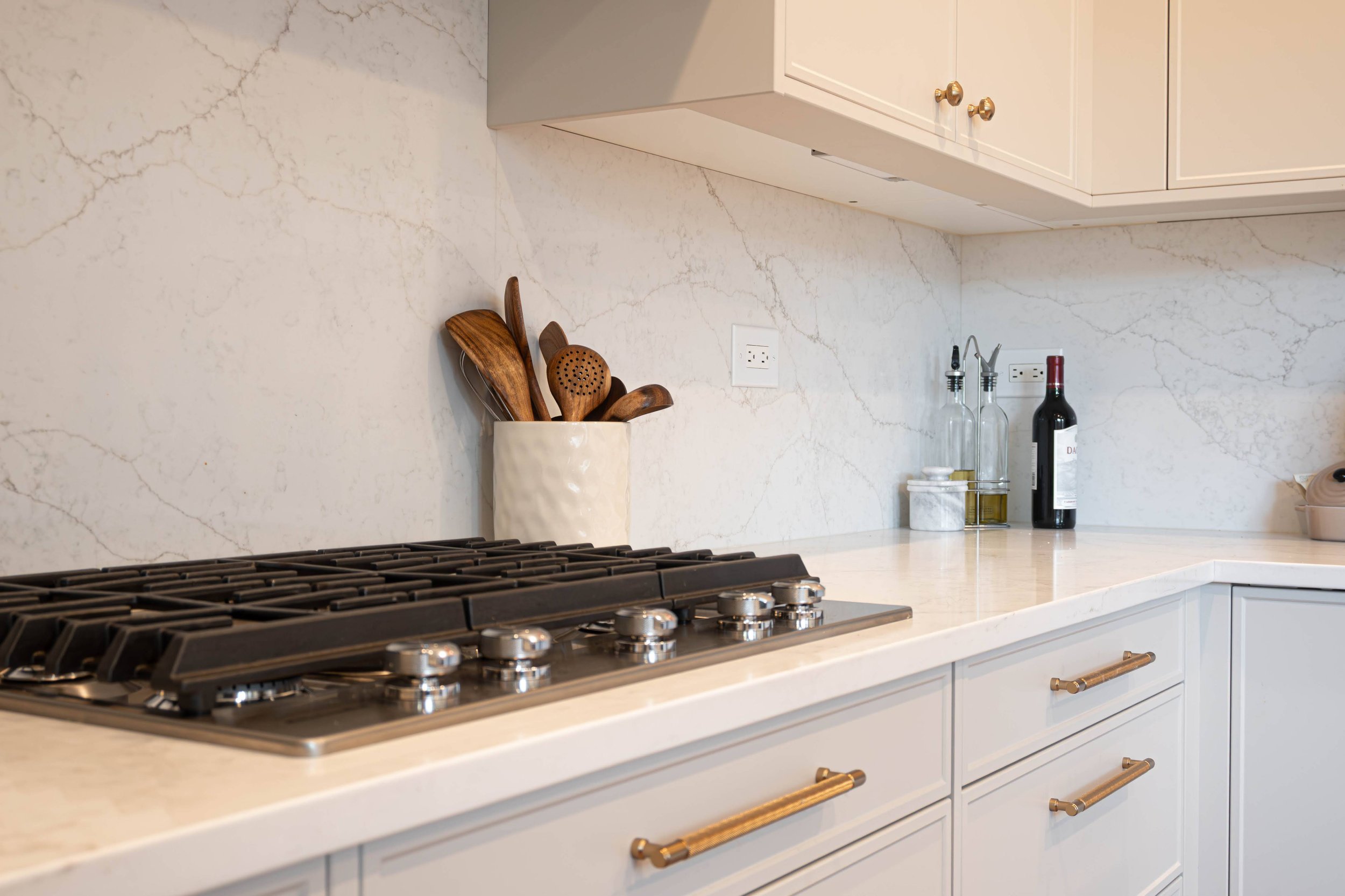 A styled functional cooking space featuring aesthetic kitchen essentials and oils, embodying a sophisticated and livable Chicago interior design style.