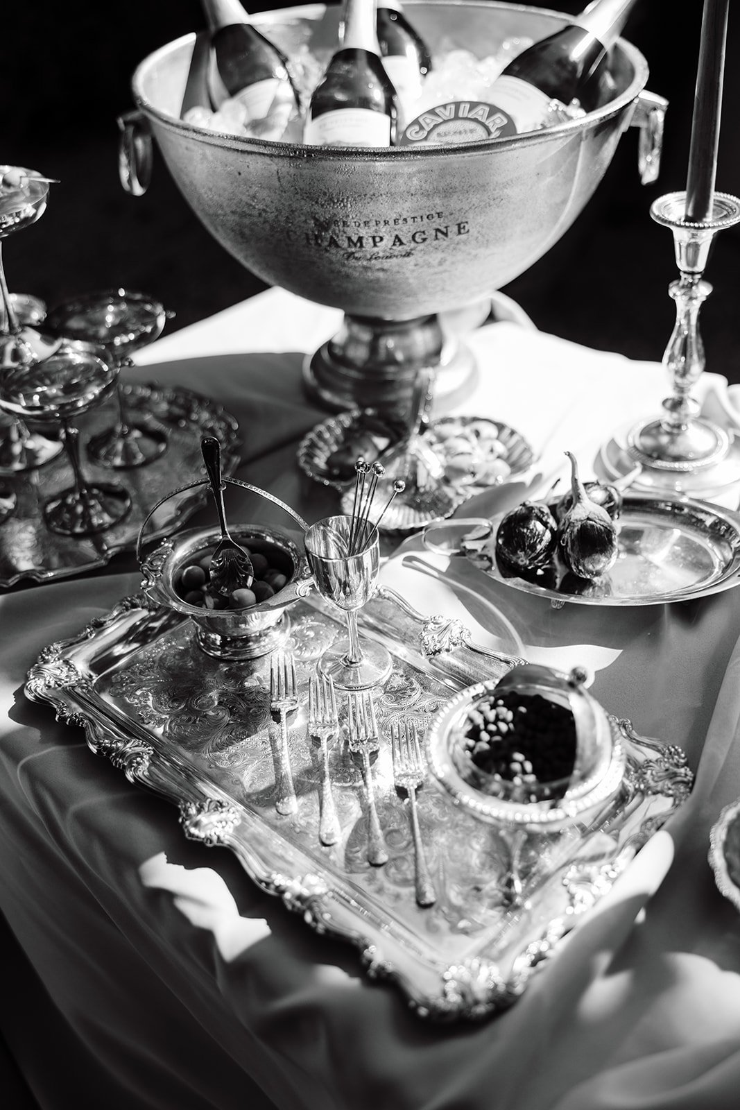 Detailed photo of silverwear, caviar tins, caviar, champagne on ice