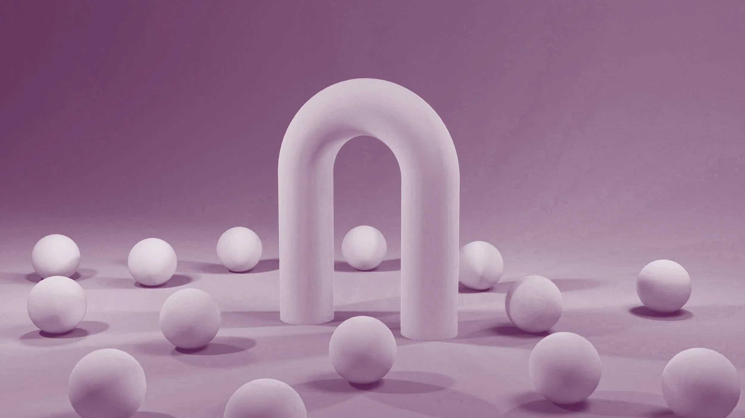 A white horseshoe-shaped sculpture surrounded by white spherical objects on a pink background.