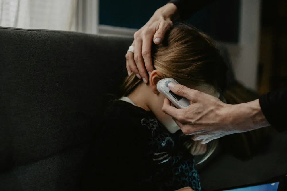 Child having their temperature taken.