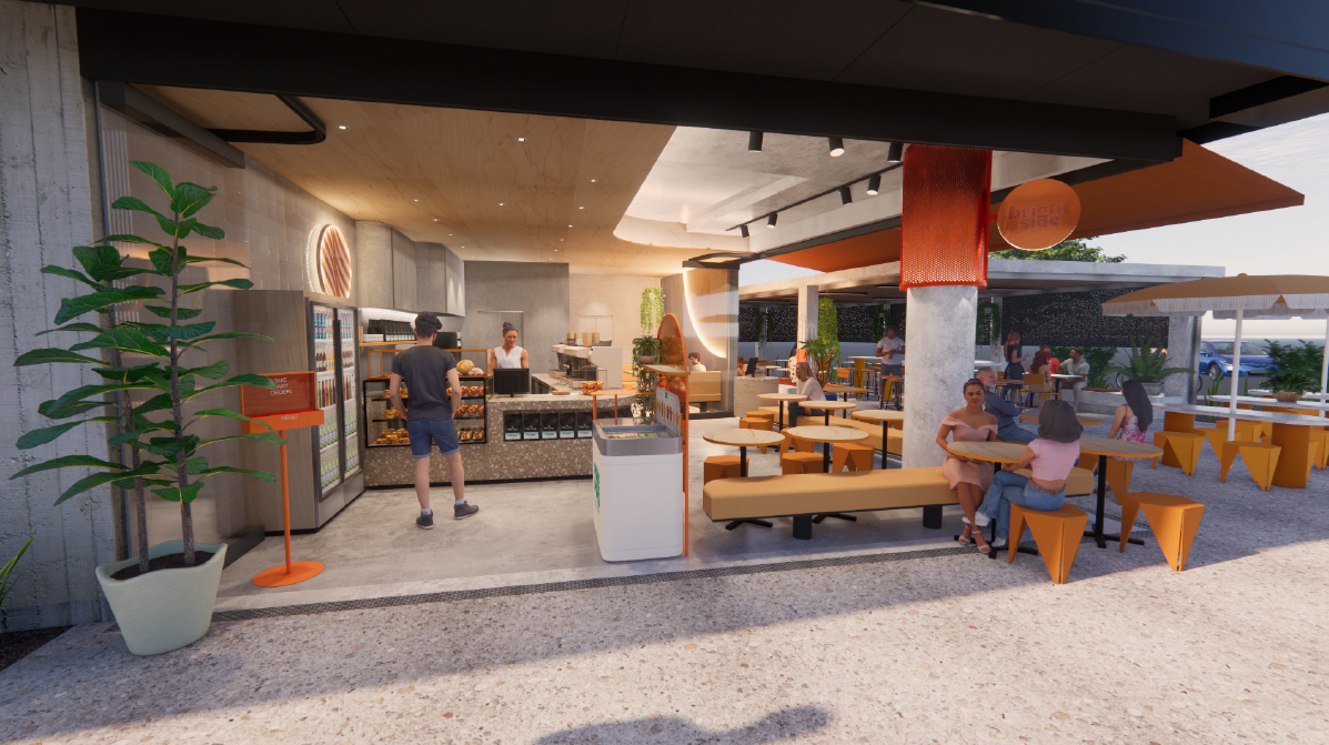 Outdoor seating area of a modern café with people sitting at tables, some ordering at the counter, and a few standing around, surrounded by plants and shaded areas.