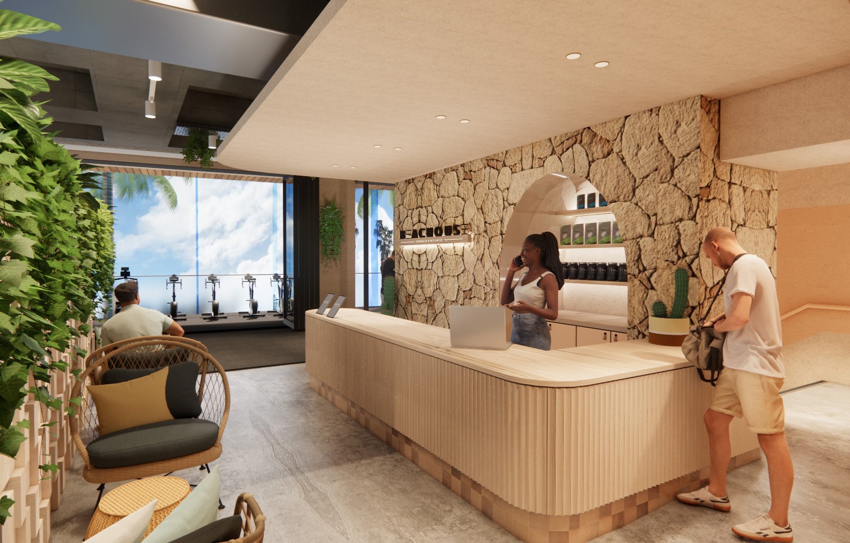 Indoor reception area with a stone wall, a wooden counter, and two staff members talking on the phone. There are plants, seating, and a large window revealing a cloudy sky and palm trees outside.
