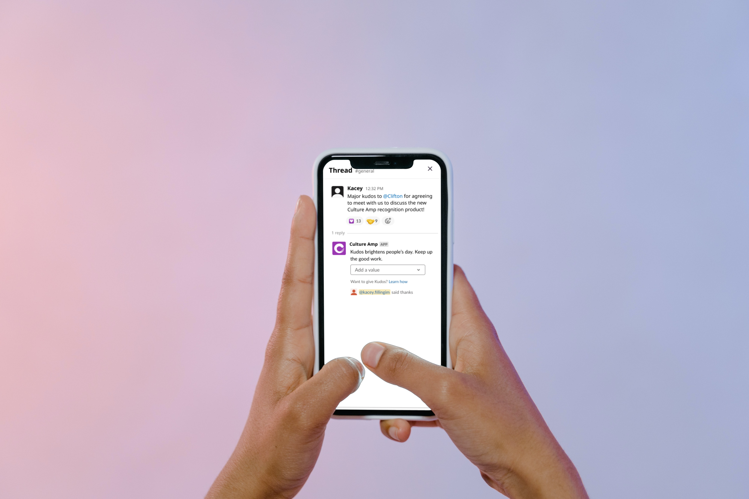 Person holding a smartphone with a social media conversation on the screen, against a pastel gradient background.