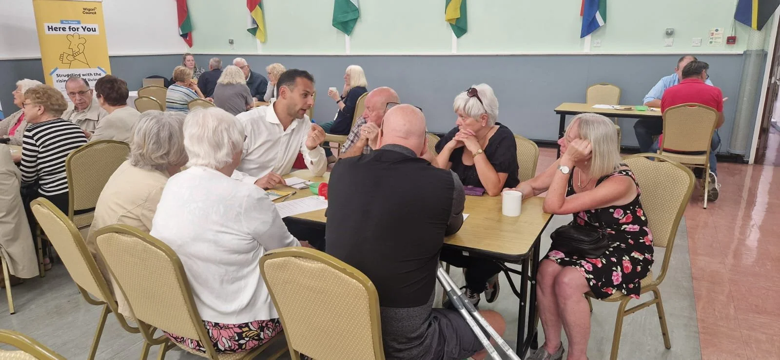 Multiple people engaging in conversation at an MP coffee morning