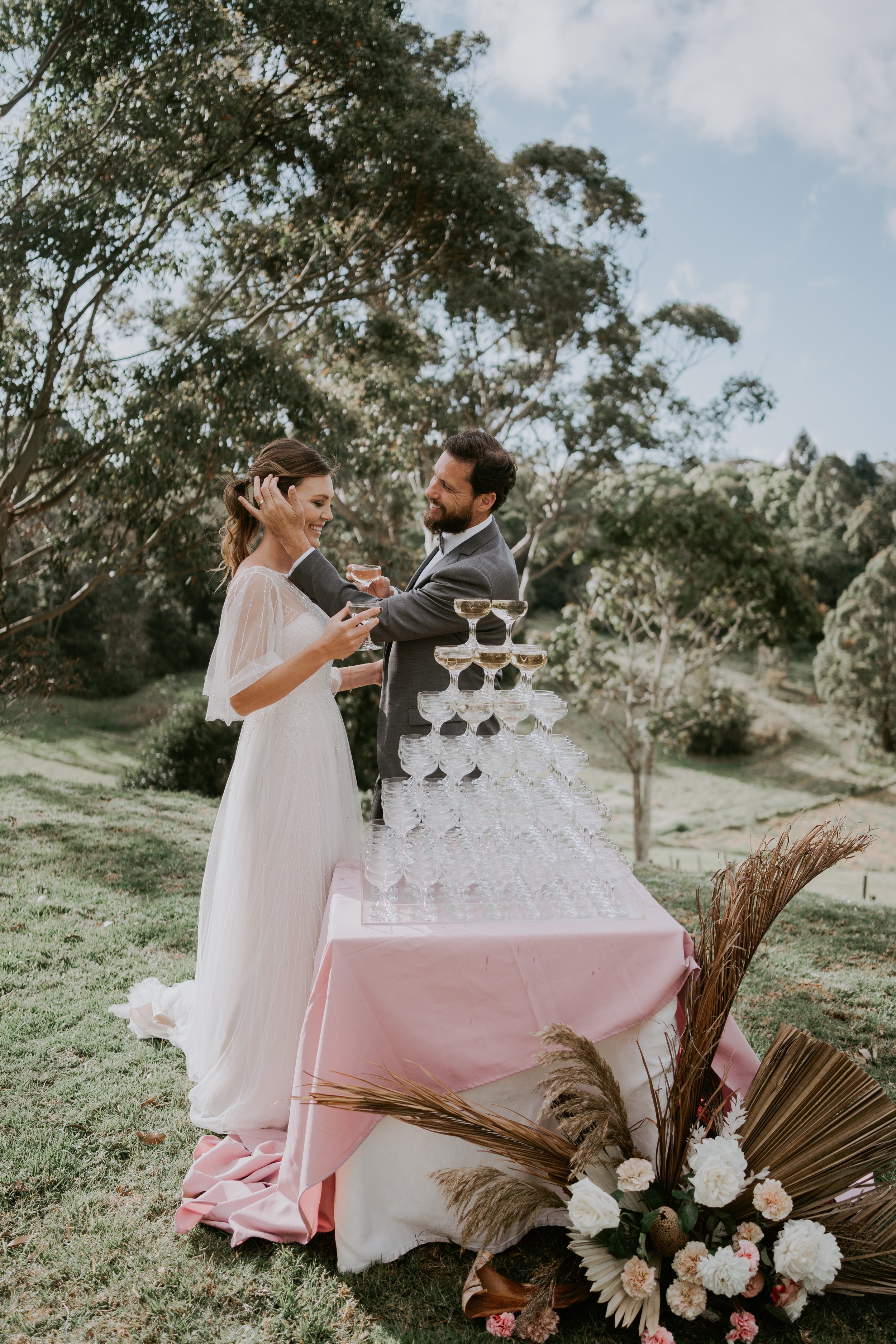 A newly married couple cutting their wedding cake at Mason Winery