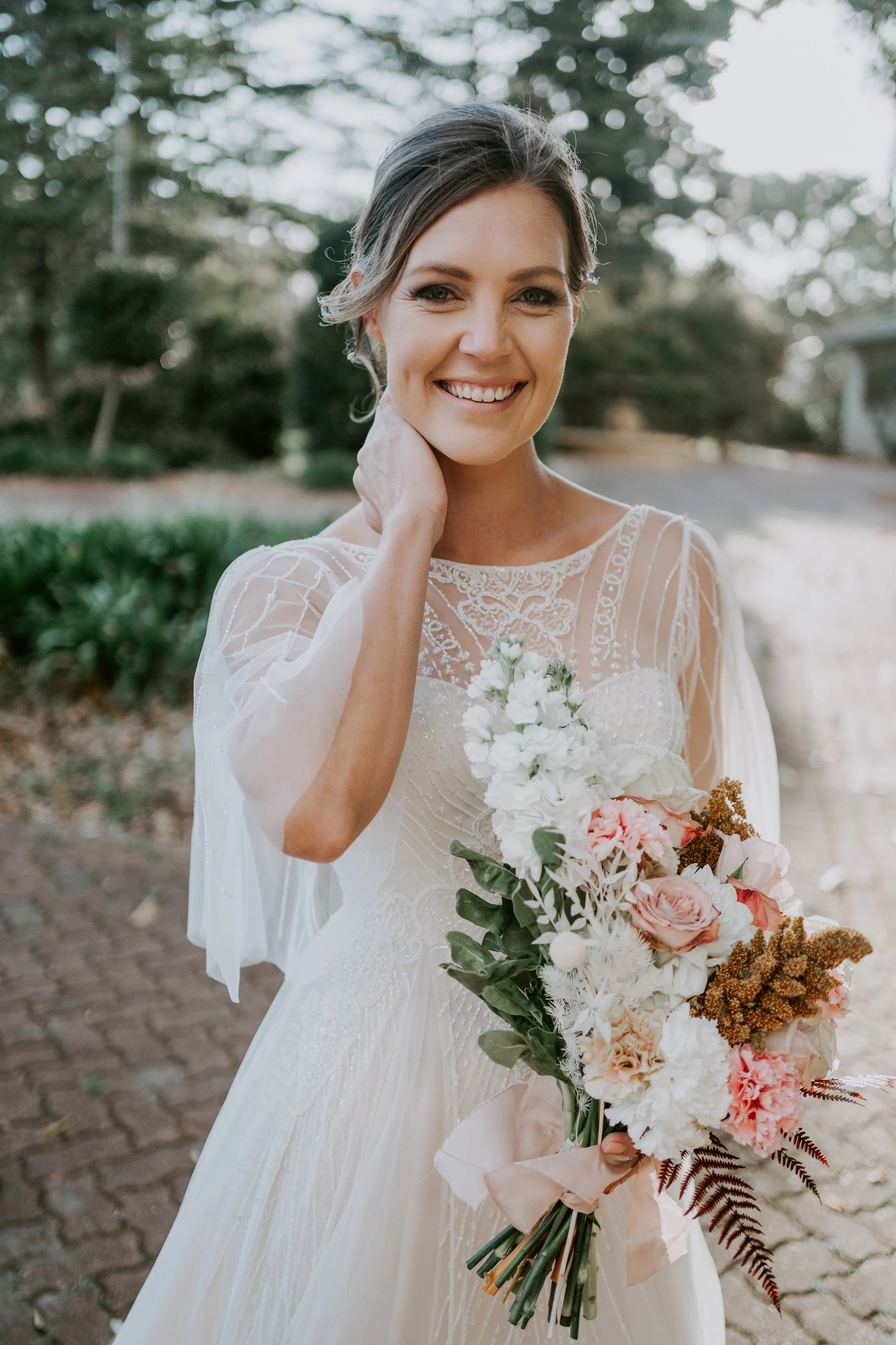 A bride holding her bouquet in the Mason Winery gardens