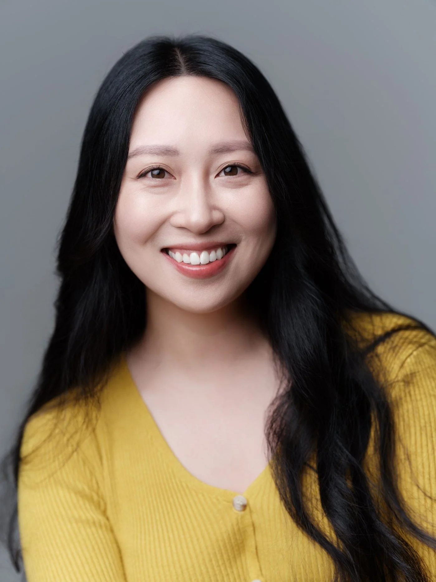 minimax-headshot-yellow-cardigan.jpg