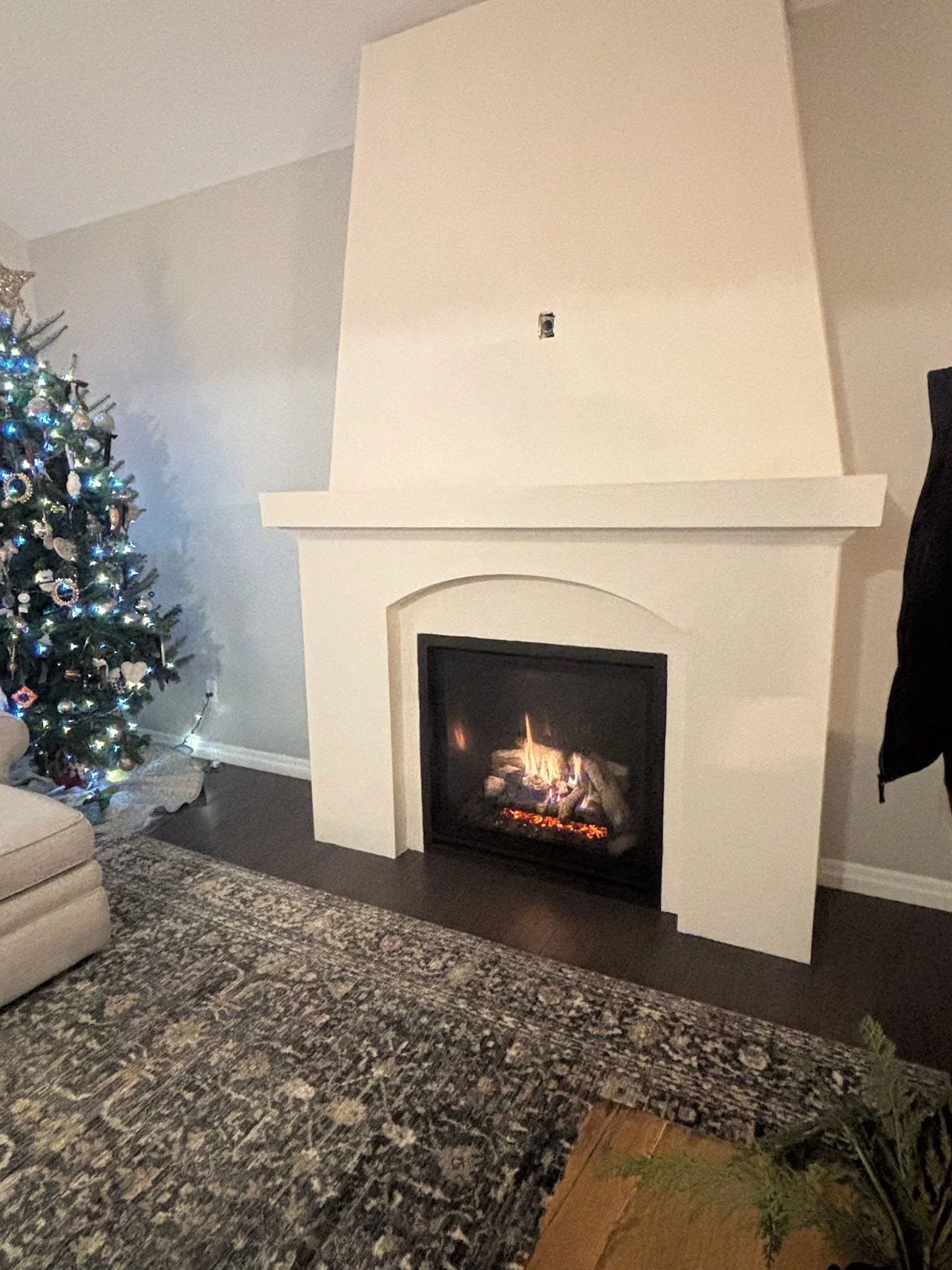 Living room with a unique fireplace finished with paint.