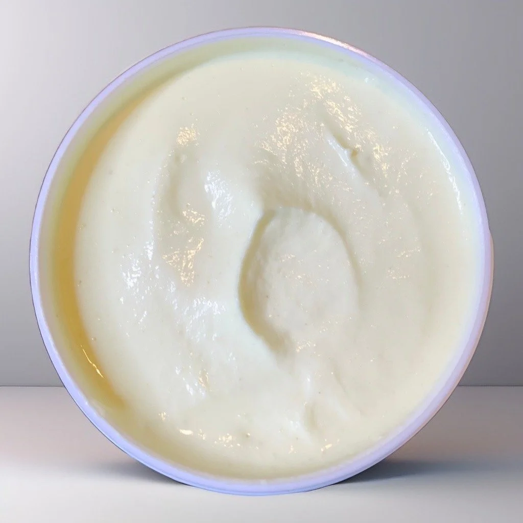 Close-up of a container of creamy, white face and hair moisturizer