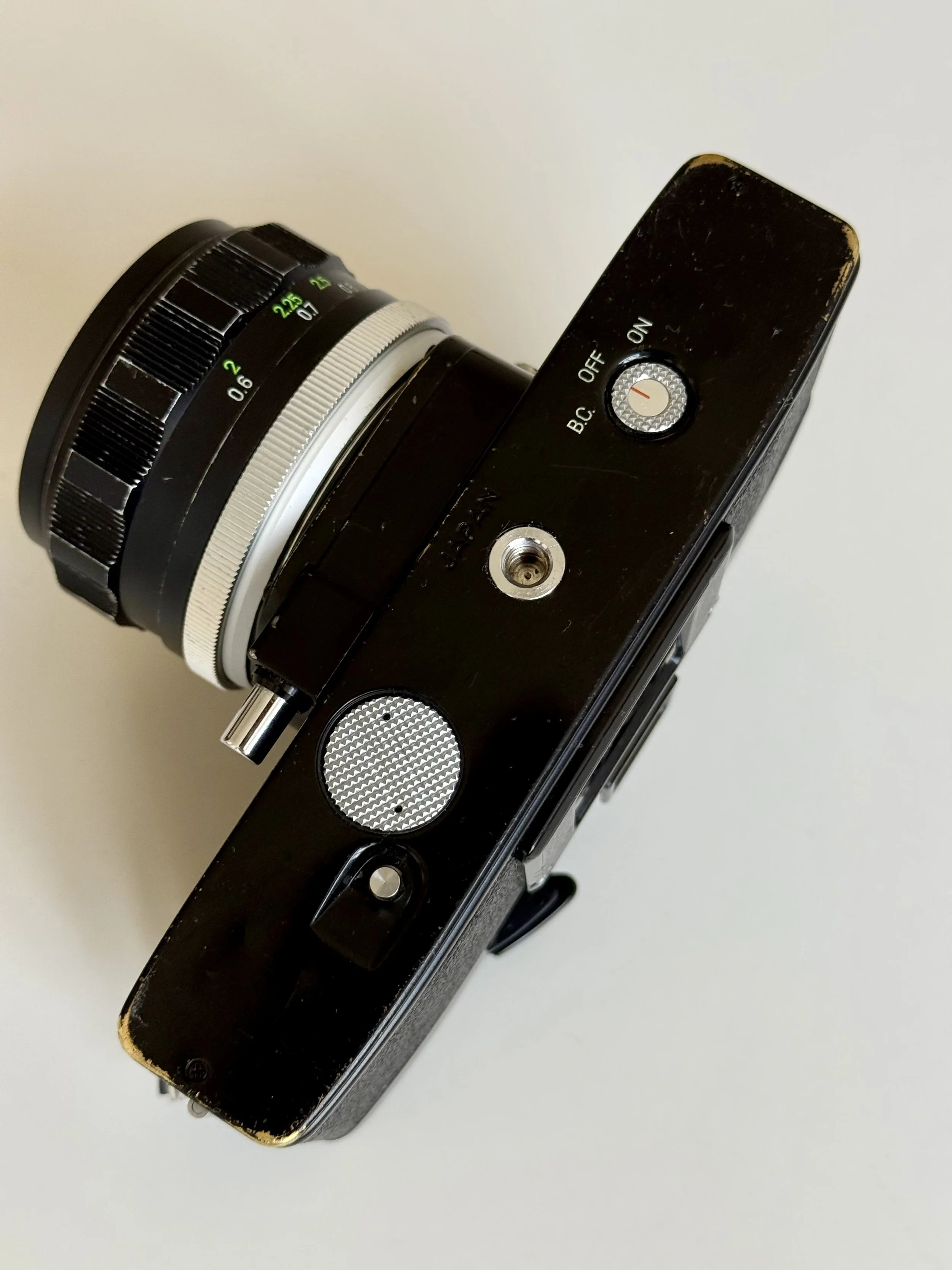 Close-up of the hidden light meter switch on the Minolta SR-101, showing the ON/OFF position for the internal needle metering system.