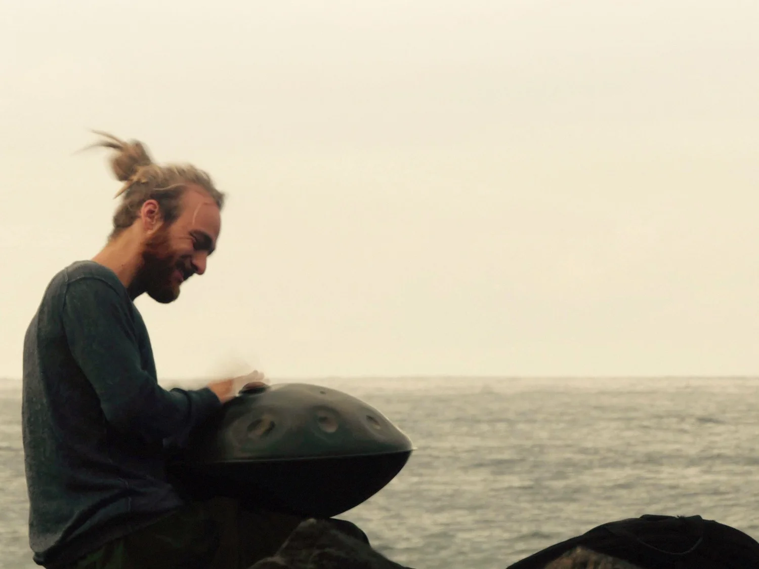 Malte Marten playing the handpan by the sea in his early years