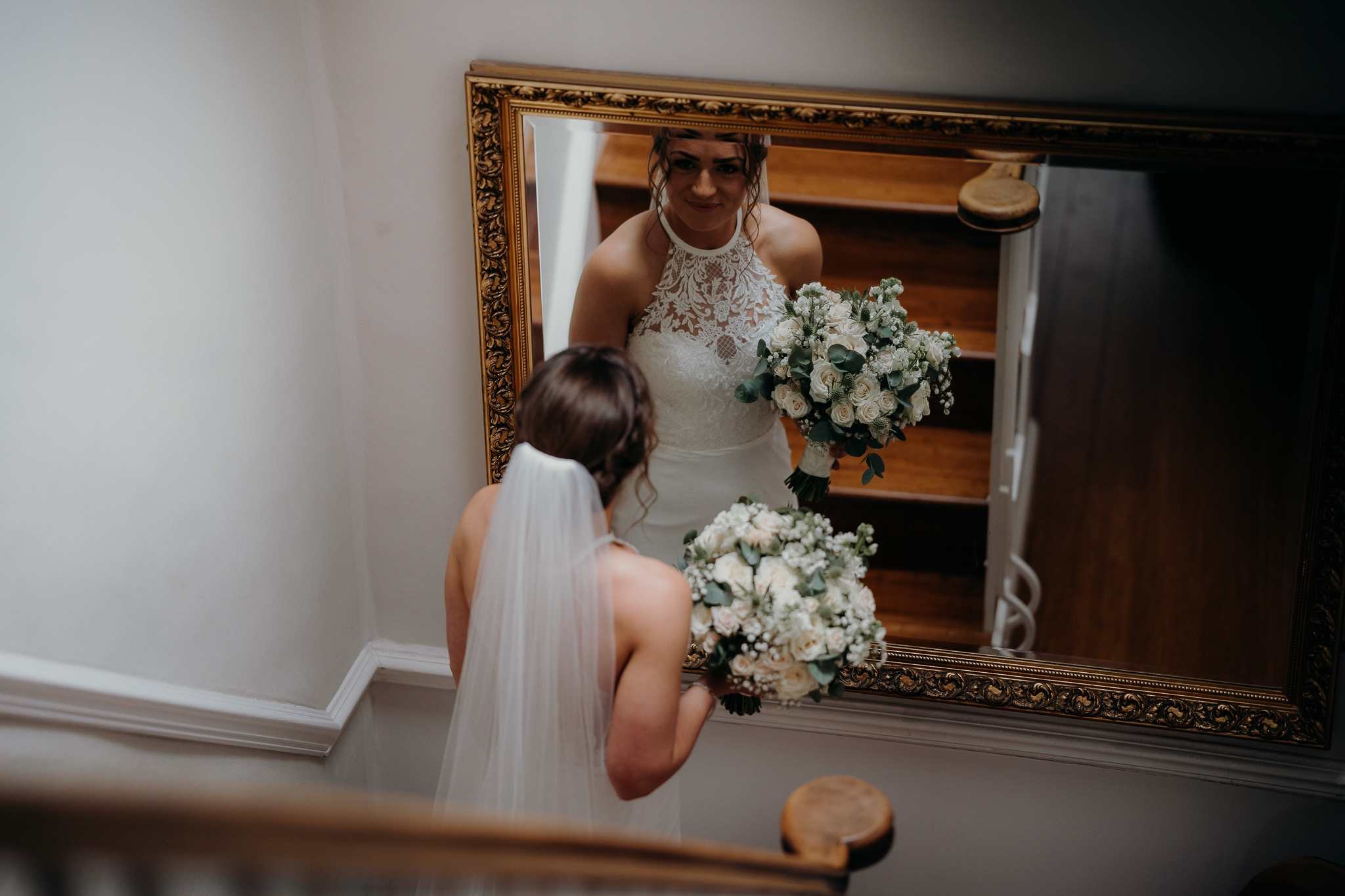 Bride and her first look at the mirror before she walks down the aisle