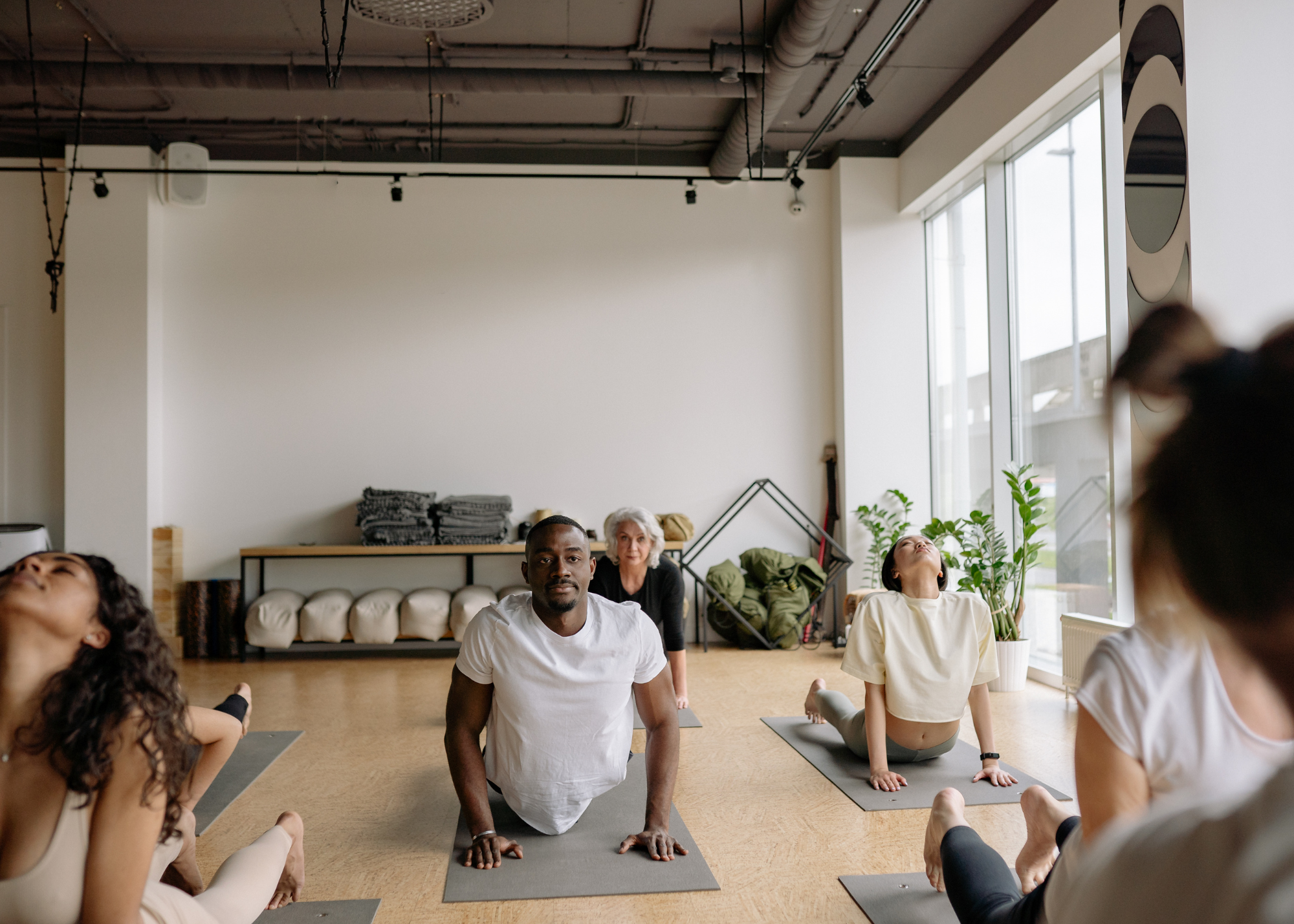 Men and women practicing yoga for hormone balance and overall wellness through HRT and BHRT treatment.