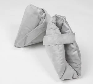 Two crumpled, unused white paper or fabric bags on a white background.