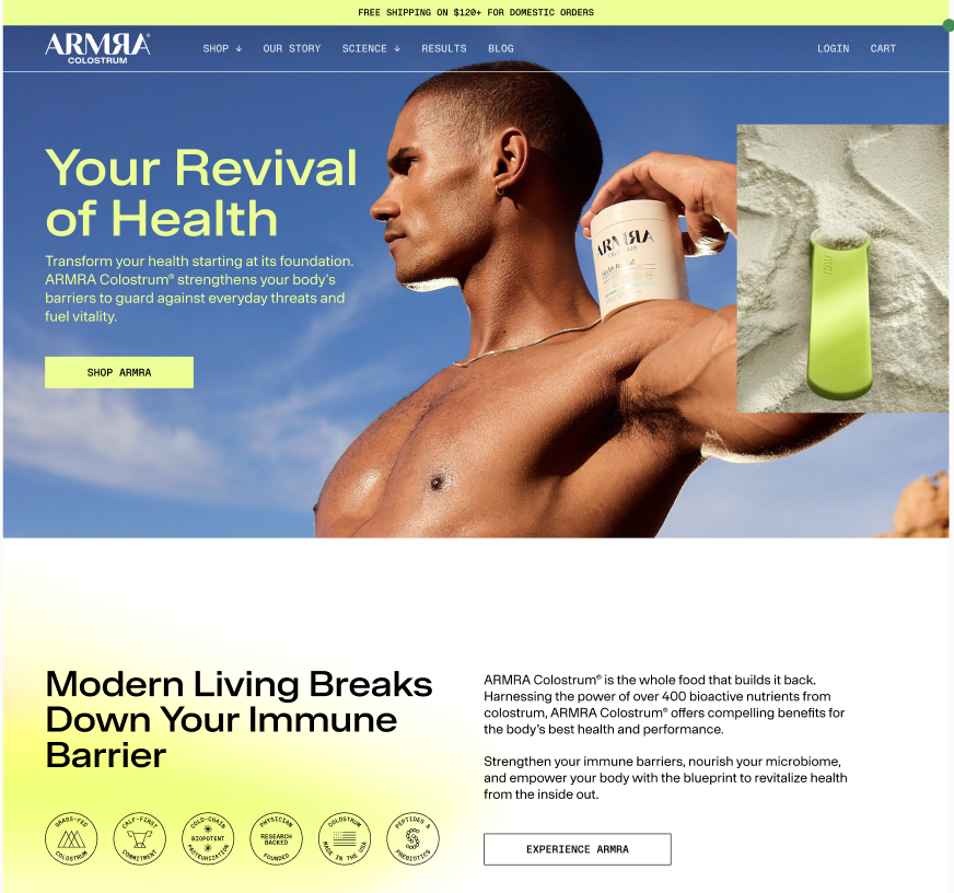 A young man with a shaved head holding a white container of ARMA Colostrum supplement on his shoulder in an outdoor setting with a partly cloudy blue sky. An inset close-up shows a green device on a sandy surface.